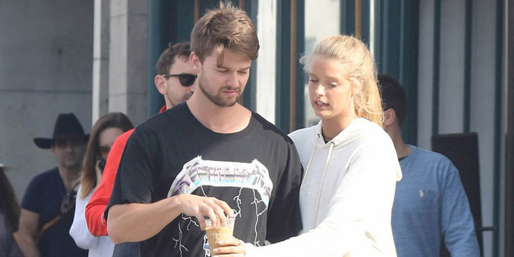 Patrick Schwarzenegger heads toward the Neon Carnival with his girlfriend Abby Champion. 
