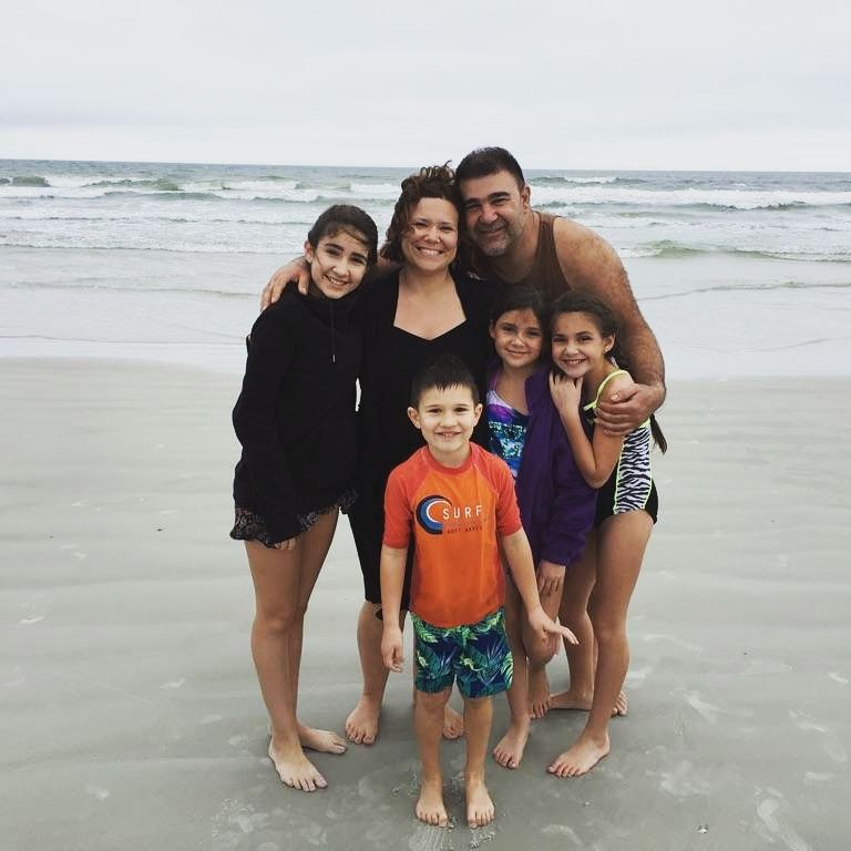 Vincent standing with his family members on sea shore 