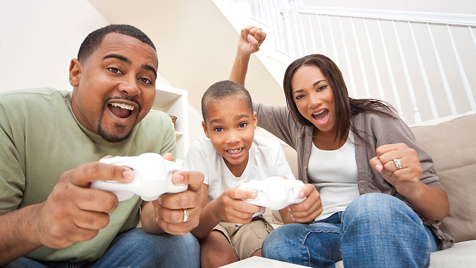 A family playing video game with controllers.