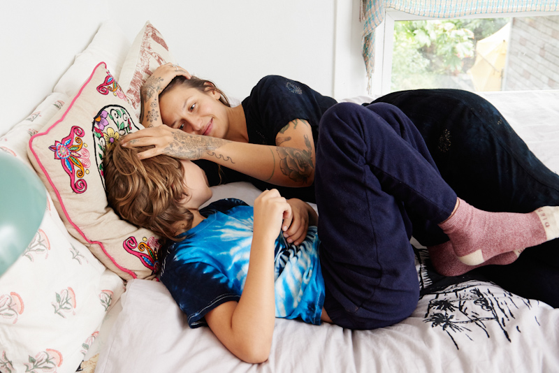 Domino Kirke and son Cassius pose for a picture while sleeping in bed.